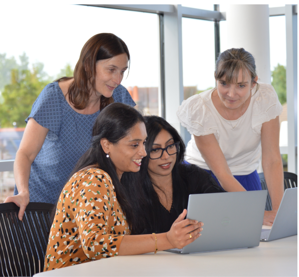 Picture of some of the Imperium(L) team around a laptop